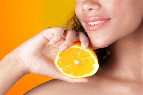 Young Smiling Black Girl With Clean Perfect Skin With Orange Stock