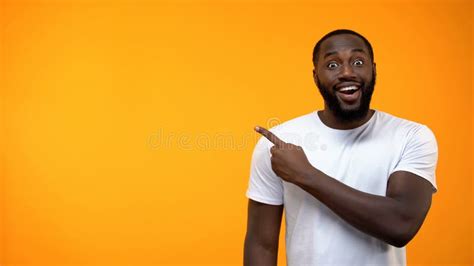 Excited Black Man Pointing Finger Into Background Template For Text