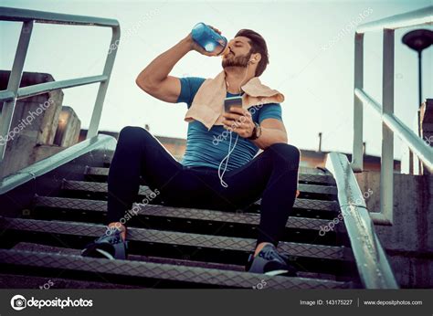 Thirsty Athlete Drinking Water After Workout Stock Photo By ©ivanko1980