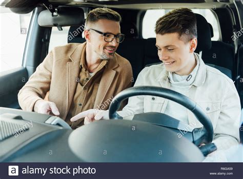 Smiling Handsome Father Teaching Teen Son Driving Car Stock Photo Alamy