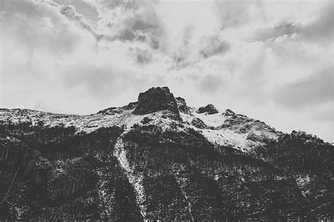 Grayscale Of Rocky Mountain Under Cloudy Sky Hd Wallpaper Peakpx
