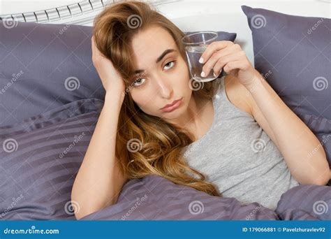 Feeling Bad From A Hangover In The Morning Young Woman Hold Glass Of