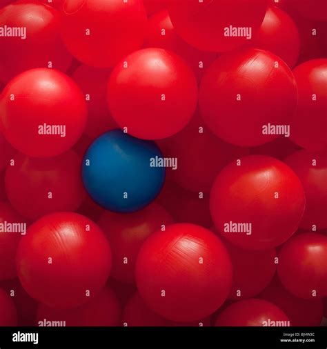 One Blue Ball Amongst Many Red Balls Stock Photo Alamy