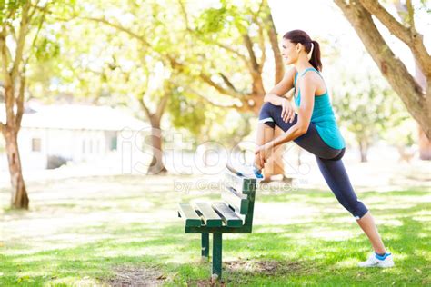 Fit Woman Stretching At Bench In Park Stock Photo Royalty Free
