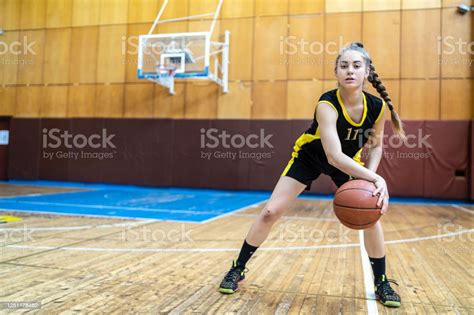 Teenage Girl Dribbling A Ball Looking At Camera Stock Photo Download