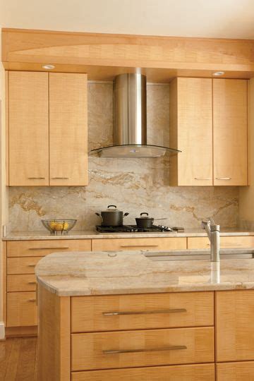 Check spelling or type a new query. Vallon paired Tiger's Eye maple cabinets with marble-like ...