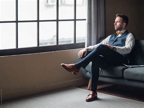 Man Wearing Suit Sitting On Couch By Stocksy Contributor Lumina Stocksy