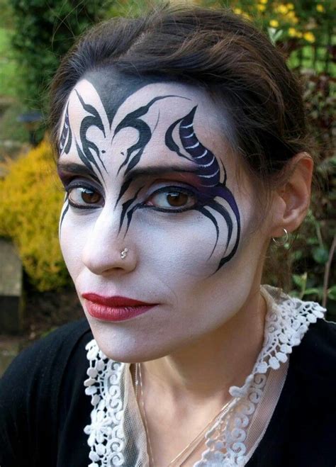 A Woman With Black And White Face Paint