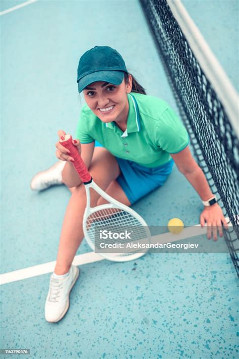 Female Tennis Player Relaxing After A Match Stock Photo Download