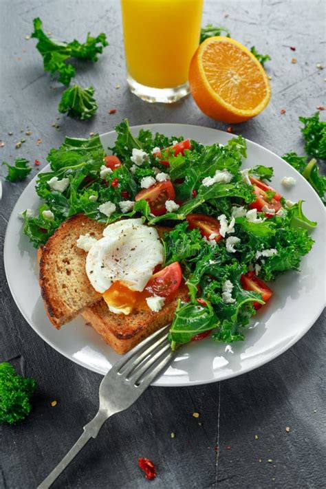 Breakfast Green Kale With Poached Eggs Feta Cheese Tomatoes And Toast