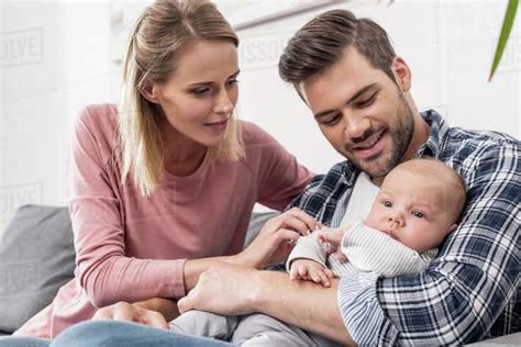 Young Parents Holding Their Little Baby Boy Stock Photo Dissolve