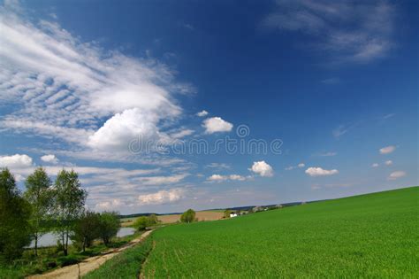 Green Field Road Blue Sky And White Clouds Stock Image Image Of
