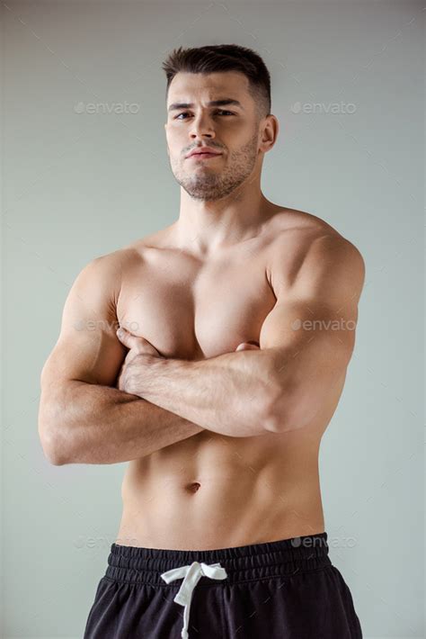Sexy Muscular Bodybuilder With Bare Torso Posing With Crossed Arms