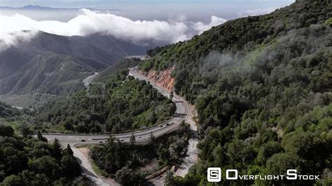 Overflightstock Trees Mountains Fog And Curvy Roads Drone Aerial