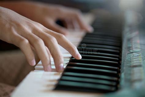 Playing The Piano Keyboard Close Up Cropped Hands Of Kid Playing Piano
