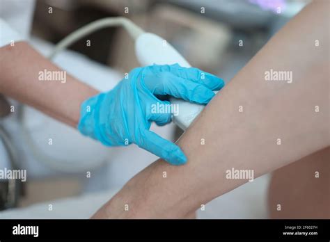 Ultrasound Diagnostics Doctor Putting Sensor On Patient Leg Closeup