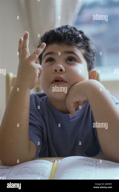 Boy Counting On His Fingers Stock Photo Alamy