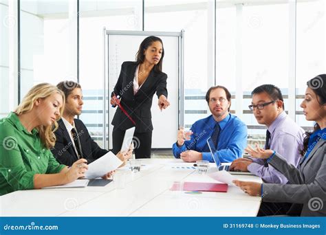 Businesswoman Conducting Meeting In Boardroom Stock Photo Image Of