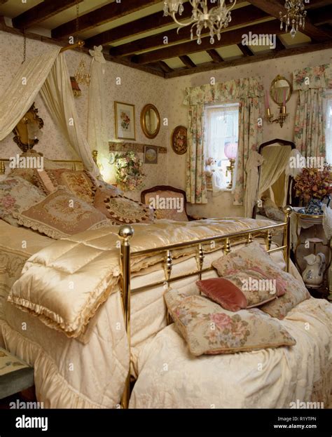 Brass Bed With Satin Eiderdown In Old Fashioned Bedroom Stock Photo Alamy