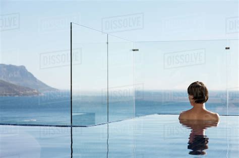 Woman In Infinity Pool Enjoying Ocean View Stock Photo Dissolve
