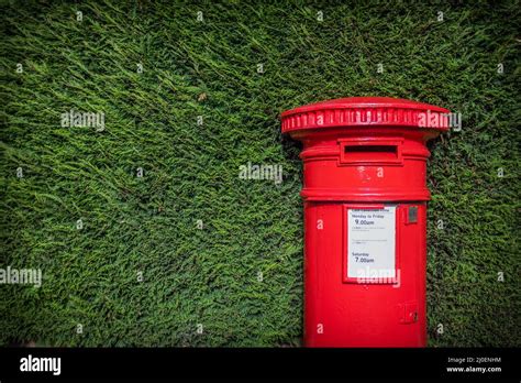 Classic Red British Pillar Box Against Hedge Stock Photo Alamy