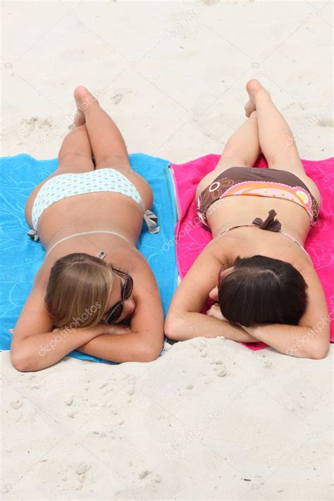 Girls Sunbathing On The Beach Stock Photo By Photography