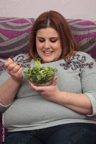 Smiling Overweight Woman Eating Salad Sitting In The Couch Buy This Stock Photo And Explore