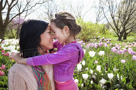 Mother And Daughter Rubbing Noses In Park Stock Photo Dissolve