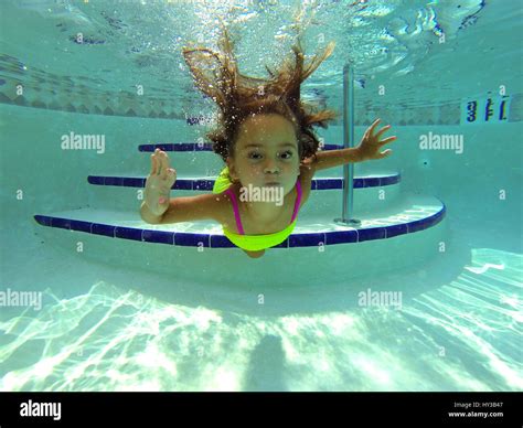 Underwater In Pool Little Girl Swims To Camera Stock Photo Alamy