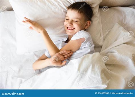 Cute Little Caucasian Boy Wake Up In His Comfortable Bed In The Morning