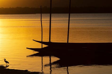 Premium Photo Silhouette At Sunset Of Canoes Docked In The Grandiose