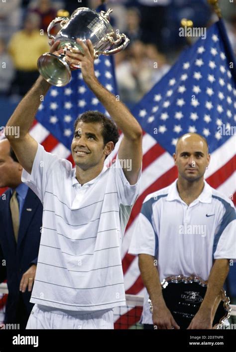 Pete Sampras Of The United States Holds The Trophy Aloft As Compatriot