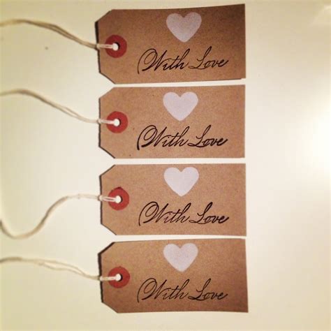 Three Brown Tags With White And Red Hearts Are Attached To The Side Of