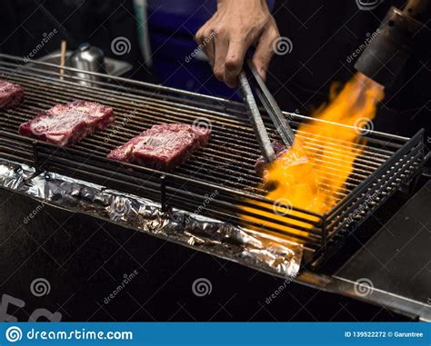 Close Up Hand Of Chef Using Flame Torch Burn On Japanese Wagyu Beef