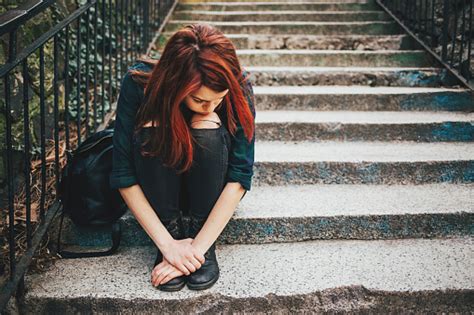 Sad Lonely Girl Sitting On Stairs Stock Photo Download Image Now Istock