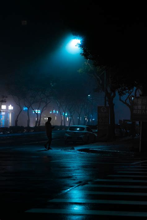 Man Walking On Street During Night Time Photo Free Person Image On