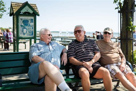 Three Older Men Enjoying A Laugh At A Park