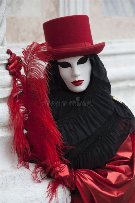 A Venice Mask Dressed In A Shiny Red And Black Costume At The Venice