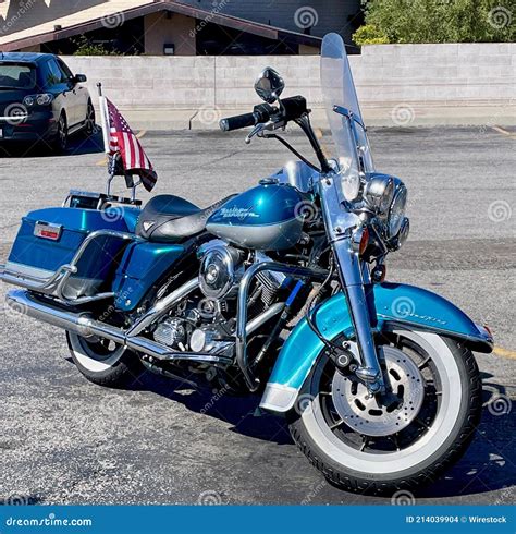 A Blue Harley Davidson Road King Motorcycle With White Wall Tires