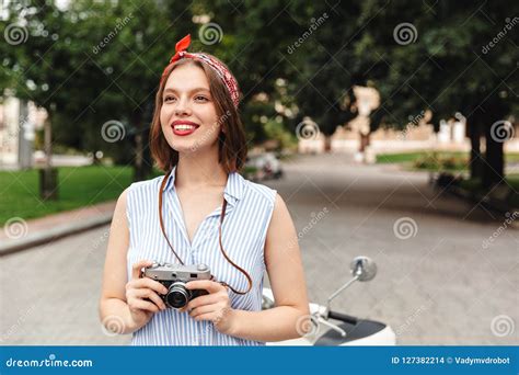 Happy Hipster Woman Holding Retro Camera And Looking Away Stock Photo