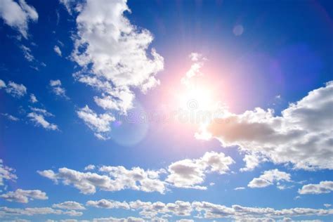 Bright Summer Sultry Sun Against Background Blue Sky And White Clouds