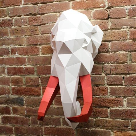 An Elephant Head Mounted To The Side Of A Brick Wall