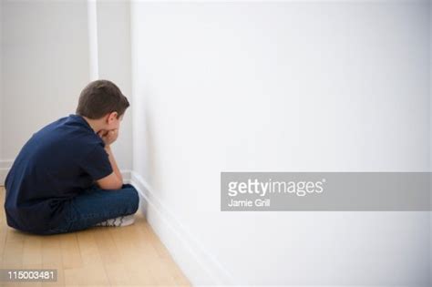 Young Boy Sulking In Corner High Res Stock Photo Getty Images