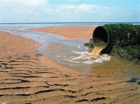 sewage pipe on a beach stock image e830 0103 science photo library