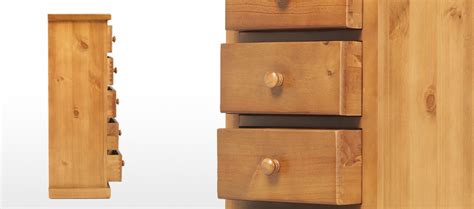 Same bracket feet, same large raised side panel, but stretched to hold eight drawers of which the middle and bottom rows are deep ones. Devon Pine 5 Drawer Tall Chest of Drawers | Quercus Living