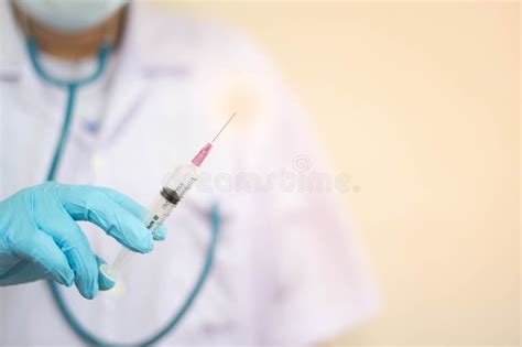 Syringe Medical Injection In Hand Holding With Medicine Dose