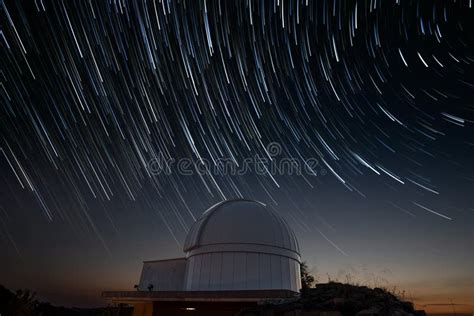 Astronomical Observatory Under Star Trails Sky At Night Stock Photo