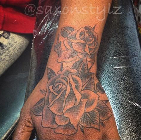 The calming moon tattoo on foot: @saxonstylz Beautiful hand rose tattoo done on dark skin ...