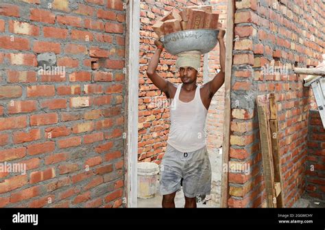 Labor Carrying Brick On Head At Construction Site Stock Photo Alamy