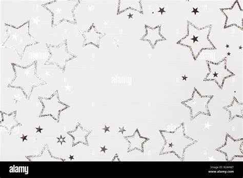 Holiday Background Of Silver Stars With Sparkles On White Wooden
